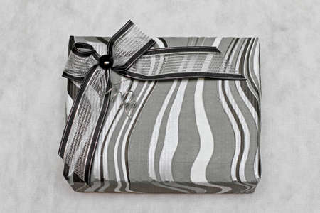 Modern silver gift box with decorative bow
