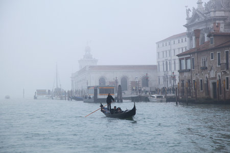 Venice, Italy - December 18, 2012: One Gondola in Winter Fog at Grand Canal in Venice, Italy.のeditorial素材