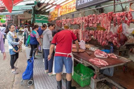 KOWLOON, HONG KONG - APRIL 22, 2017:  People Shopping at Butcher Shop in Kowloon, Hong Kong.のeditorial素材