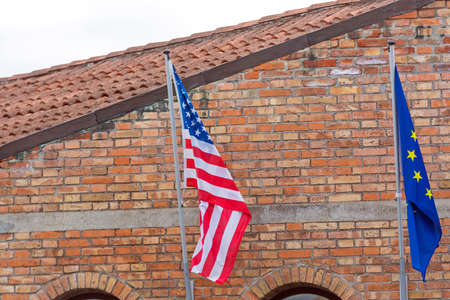 Usa and EU Flags at Brick Building