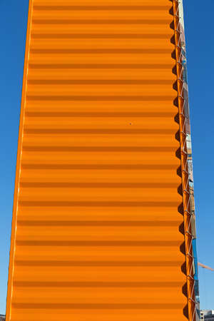 Orange Cargo Container in Vertical Position Structure