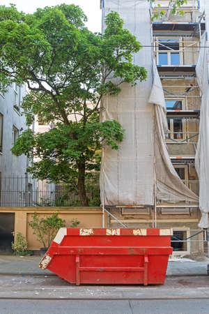Big Red Skip Container at Construction Site in City