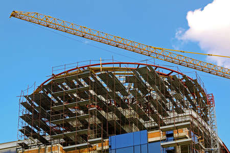 Scaffoldings at top of skyscraper building construction