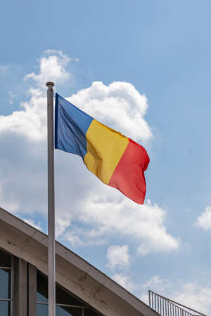 National Flag of Romania at Pole Blue Skyの写真素材