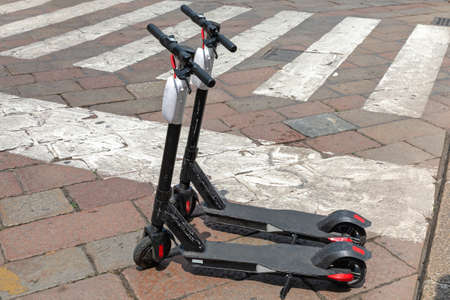 Electric Scooters for Rent Leaved at Street in City