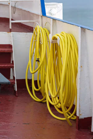 Long Yellow Water Hose at Ship Deckの写真素材