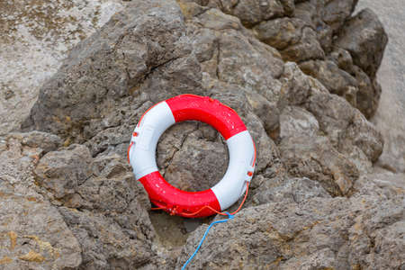 Lifesaver Buoy Ring at Rocky Coast Stonesの写真素材