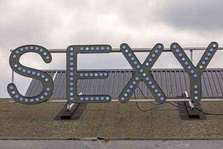 Big Sexy Light Sign at Top of Roofの写真素材