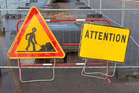 Road Works and Attention Sign at Construction Siteの写真素材