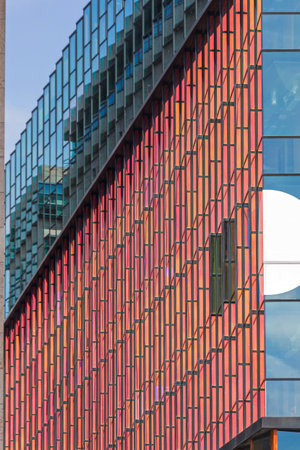 Red Glass Facade at Modern Building in Amsterdamのeditorial素材