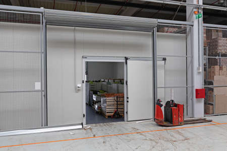 Pallet Truck in Front of Warehouse Cargo Doorの写真素材