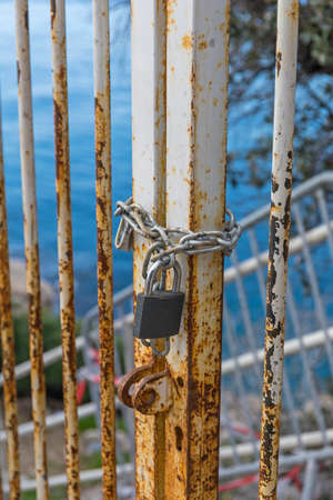 Padlock and Chain at Locked Metal Gateの写真素材