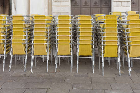 Stacked Chairs in Front of Restaurant in Veniceの写真素材