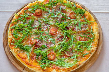 Traditional Pizza With Arugula and Tomato Italian Cuisineの写真素材