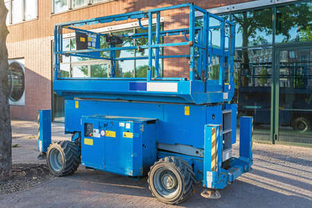 Blue Scissor Lift Aerial Work Platform at Street
