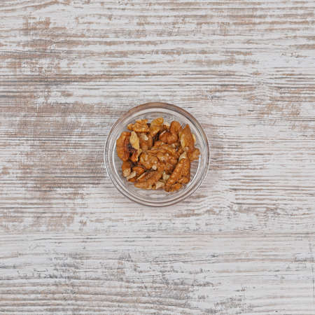 Walnuts Snacks in Small Glass Bowl at Tableの写真素材