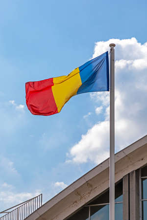 National Flag of Romania at Pole Blue Skyの写真素材