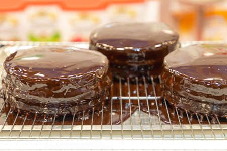 Three Chocolate Cakes Topping at Wire Rack