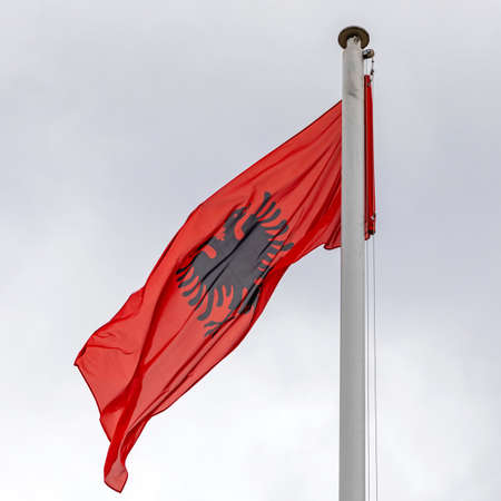National Flag of Republic Albania at Cloudy Skyの写真素材