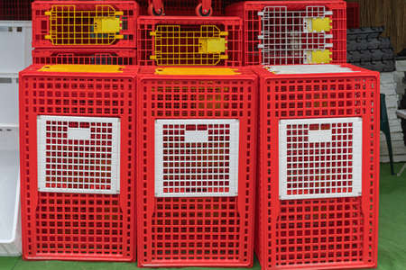Red Plastic Cages for Birds at Farm