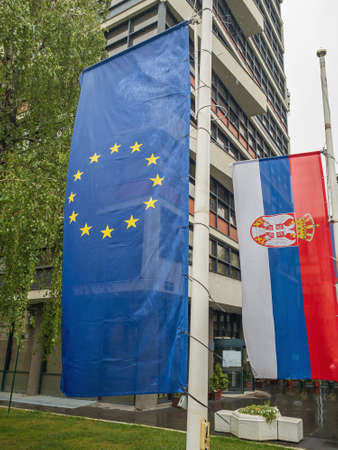 EU and Serbia Flags Together at Poles