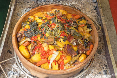 Slow Cooking in Clay Pot at Coals Fireの写真素材