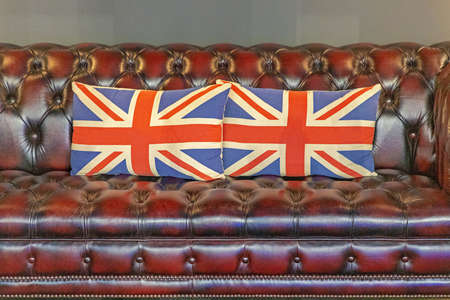 Two British Pillows at Leather Chesterfield Sofaの写真素材