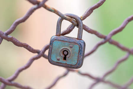 Rusty Love Symbol Padlock Locked at Fenceの写真素材