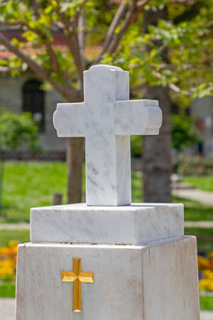 Golden Cross at White Marble Tomb Stoneの写真素材