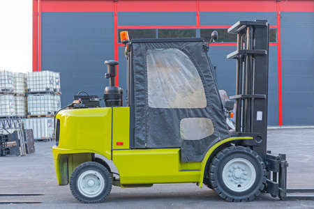 Winterize Forklift Cabin in Front of Warehouse Buildingの写真素材