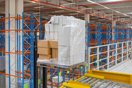 Pallet With Boxes at Forklift Gravity Flow in Distribution Warehouse