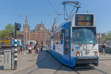 Amsterdam, Netherlands - May 14, 2018: Public Transport Tram and Central Train Station in Amsterdam, Holland.のeditorial素材