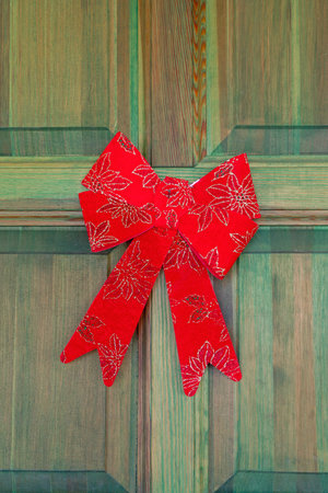 Red Bow at Green House Door Christmas Decor
