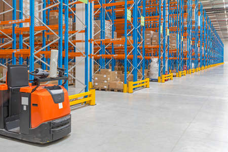 Electric Order Picker Truck in Distribution Warehouse