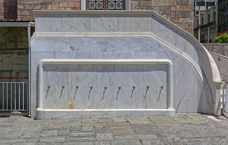Row of Water Faucets at Marble Wall Exteriorの写真素材
