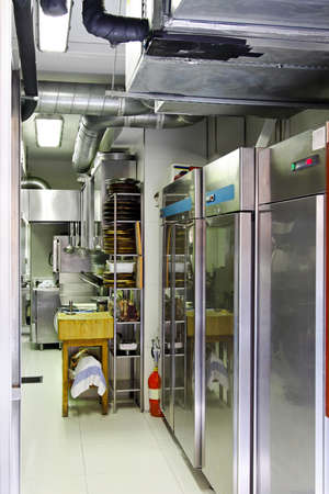Professional kitchen interior with equipment and refrigerators