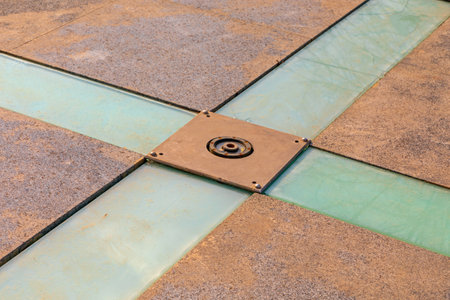 Water Jet Nozzle and Glass Floor in Empty Fountain at Cold Winter