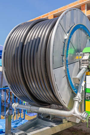 Black Plastic Water Hose at Reel Spool for Agriculture Irrigationの写真素材