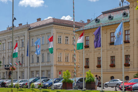Szeged, Hungary - June 16, 2021: Hungarian and European Union Flags in Front of Town Hall Szeged, Hungary.のeditorial素材