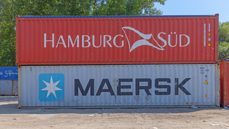Belgrade, Serbia - August 09, 2021: Stacked Cargo Containers Hamburg Sud and Maersk at Zeleznik...