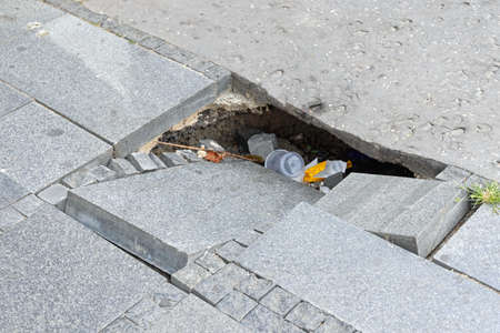 Open Sink Hole at Street With Tiles Danger