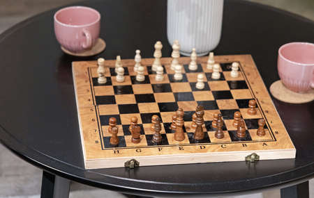 Wooden Chess Board at Coffee Table in Homeの写真素材