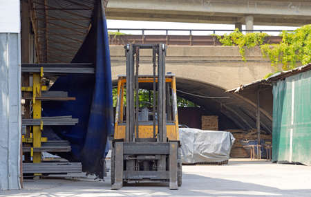 Front View of Forklift and Metal Rack With Steel Profiles Tubesの写真素材