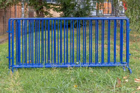 Blue Metal Crowd Control Barriers in Grassの写真素材