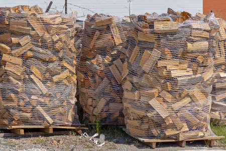 Pallets of Firewood in Net Ready for Winter Seasonの写真素材