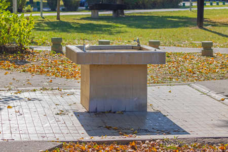 Drinking Tap Water Fountain in Park at Autumnの写真素材