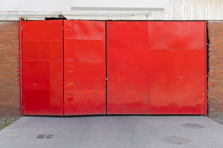 Closed Red Doors at Warehouse Building Exterior