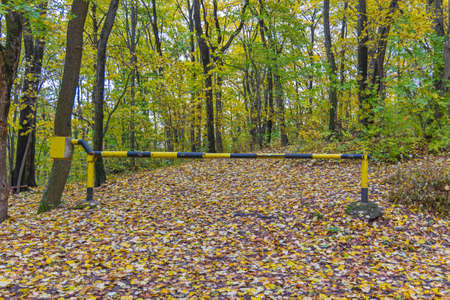 Ramp Barrier Closed Down Way to Autumn Woods