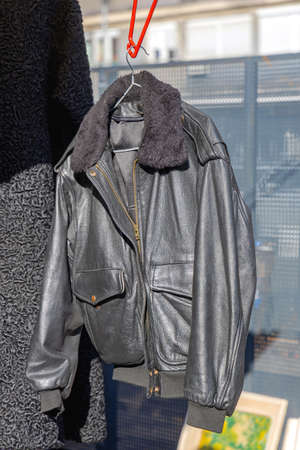 Black Leather Jacket Hanging Outside at Sunny Dayの写真素材