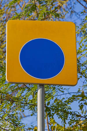 Big Blue Dot Sign at Yellow Backgrond Empty Spaceの写真素材